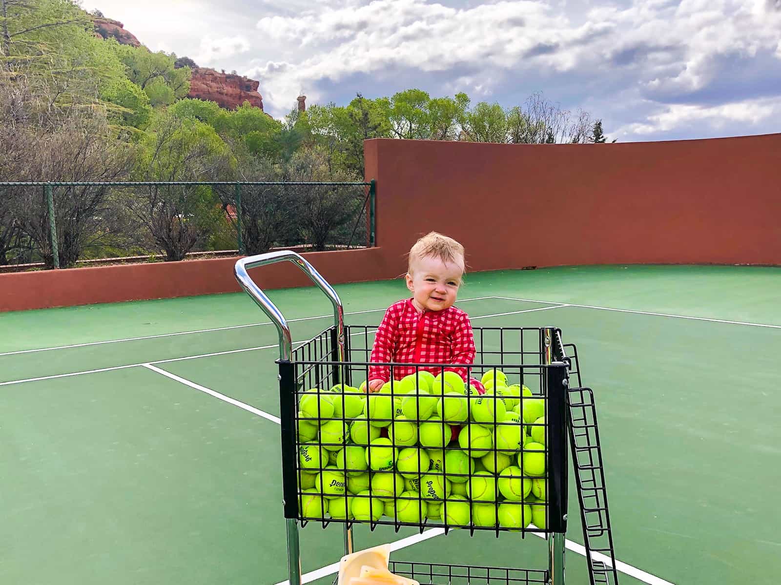baby in tennis caddy