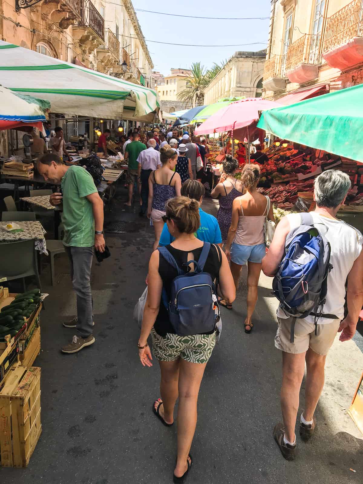 woman walking through Ortigia market - travel guide Sicily east coast