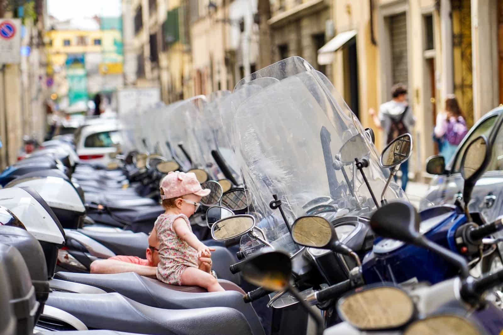 girl on a moped - florence and tuscany travel with a baby