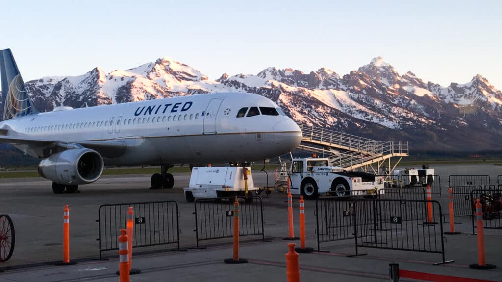 united airlines airplane on the runway at the airport - ultimate family vacation guide to jackson hole