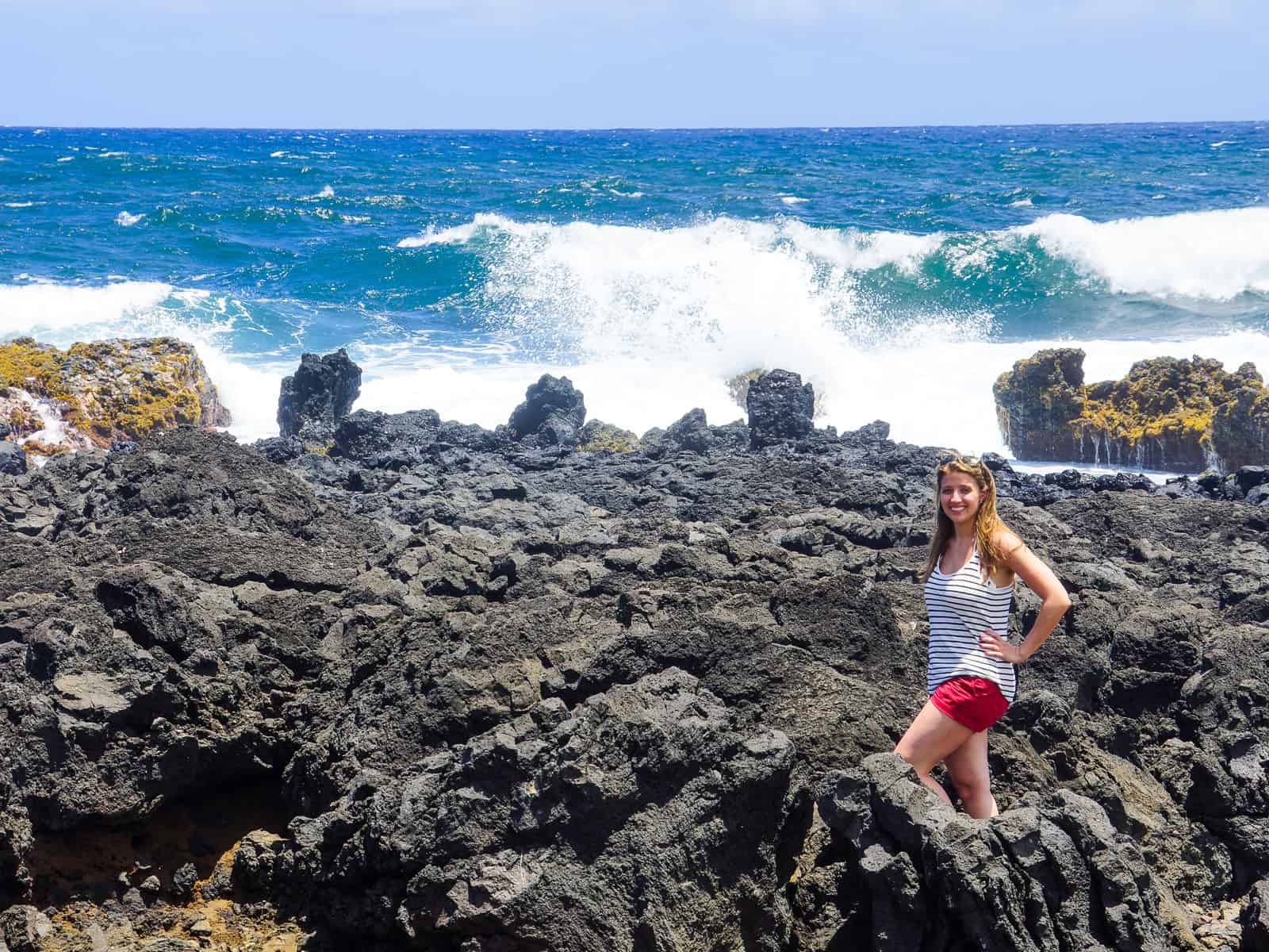 girl standing on rocks - ultimate guide road to Hana