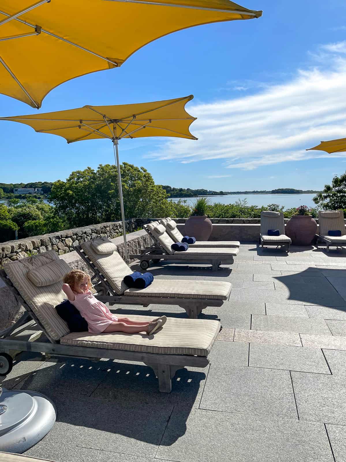 girl lounging on chair -luxury Rhode Island family resort Weekapaug Inn