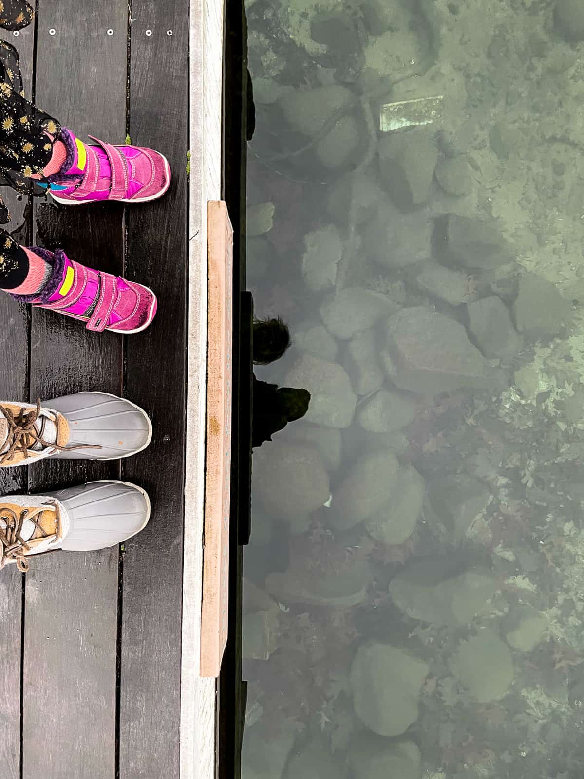 feet on the edge of a dock - sagamore resort