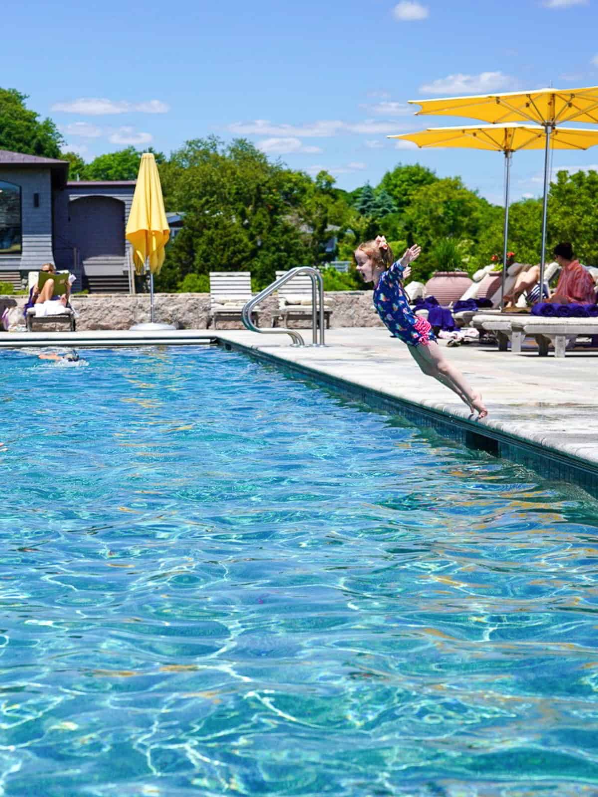 girl jumping into pool - luxury Rhode Island family resort Weekapaug Inn