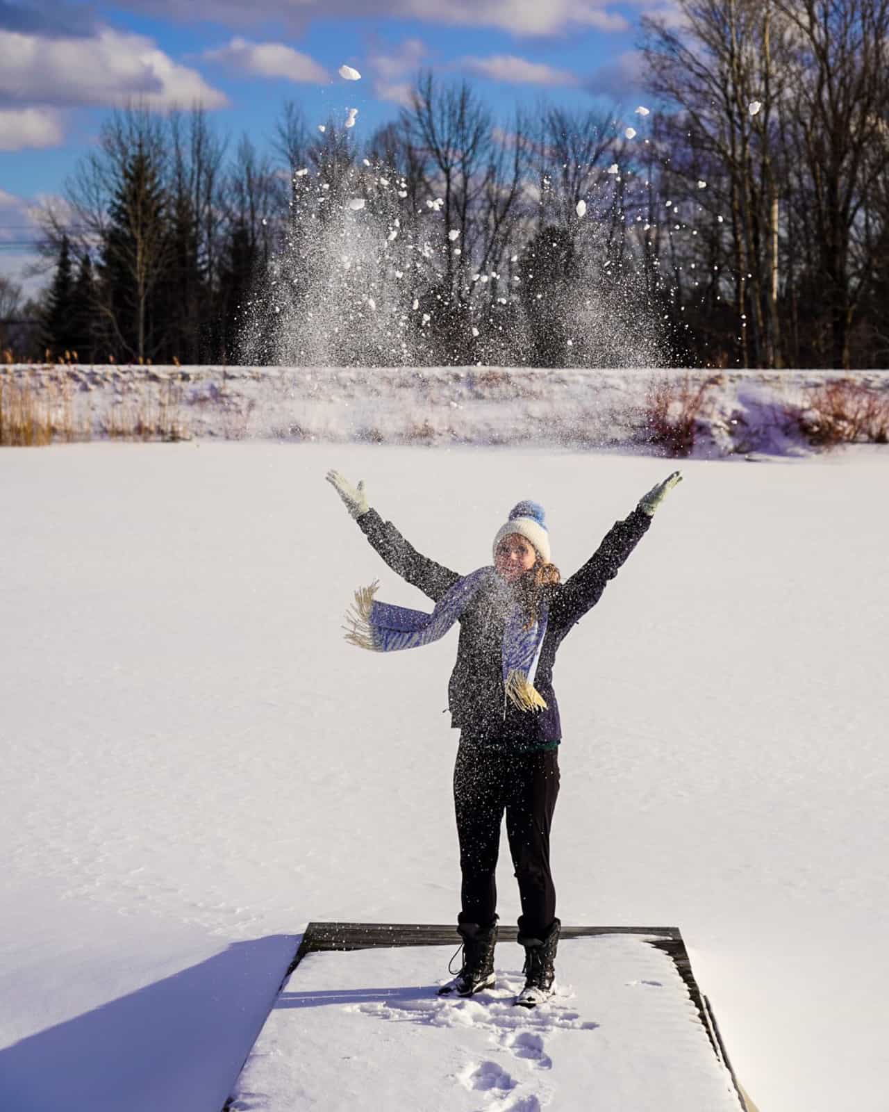 girl throwing snow - romantic Vermont getaway twin farms