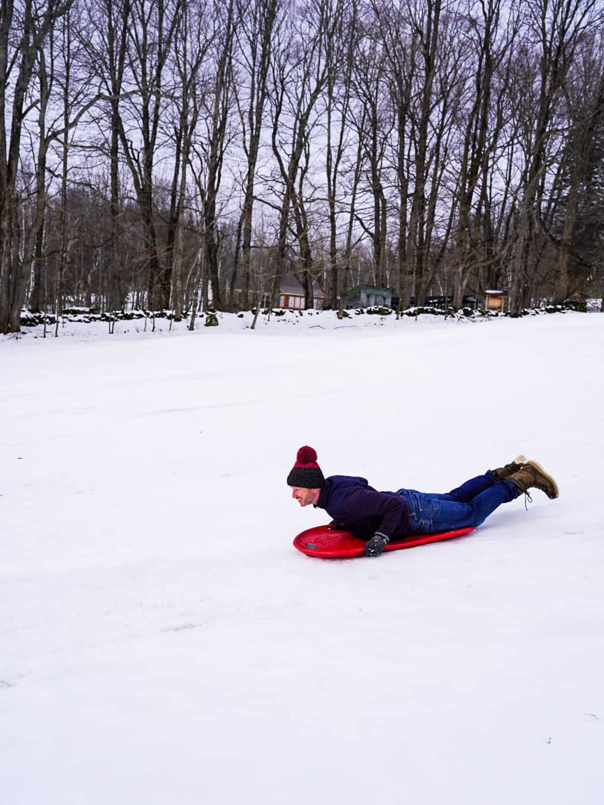 man sledding - romantic Vermont getaway twin farms