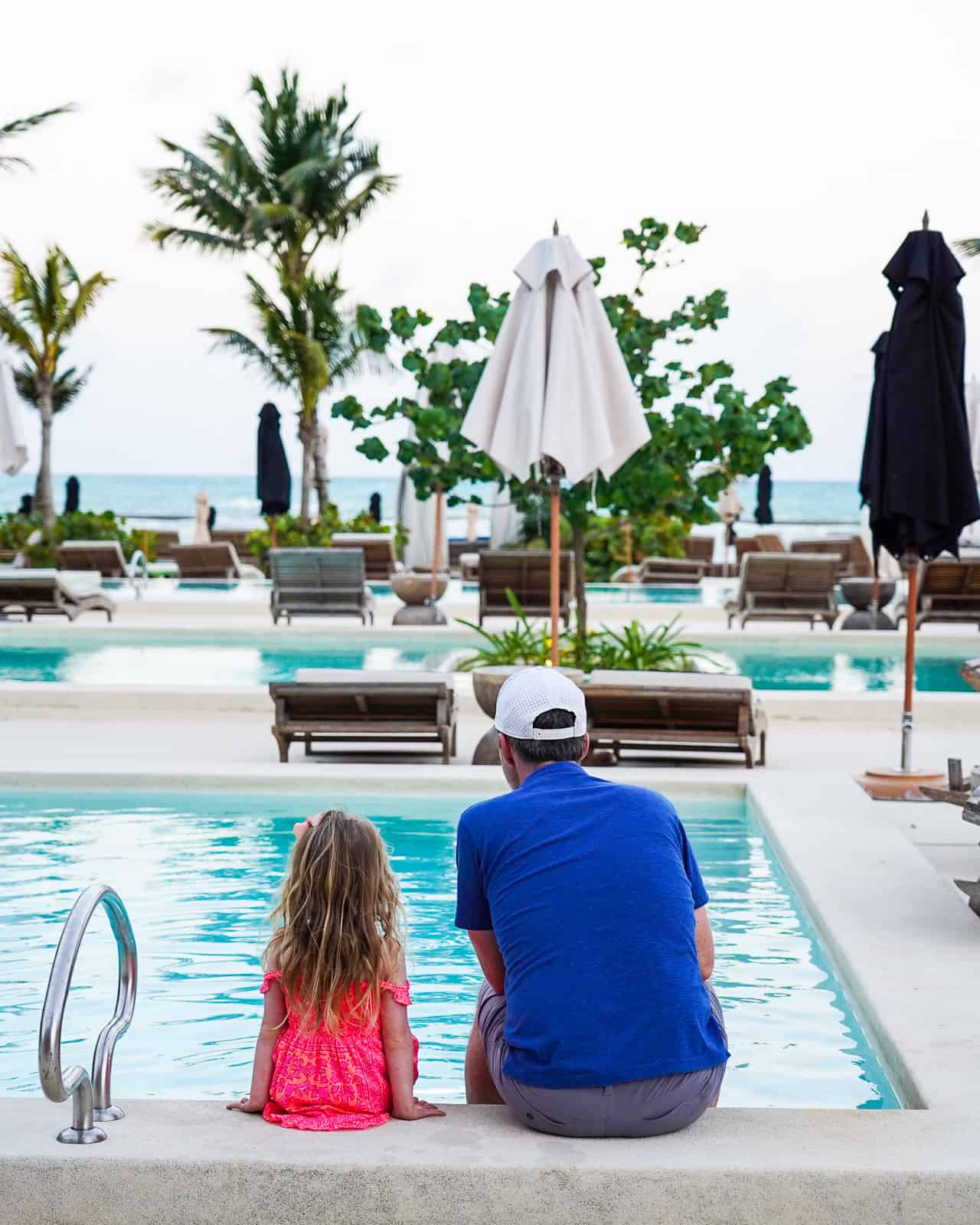 dad and daughter by the pool - rosewood mayakoba luxury family resort