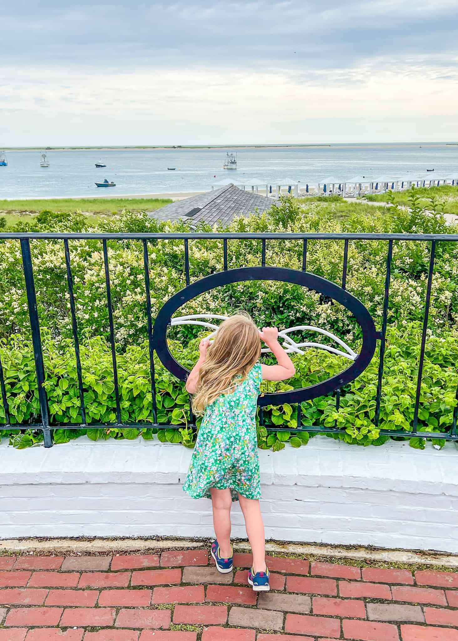 girl staring through gate - cape cod family vacation