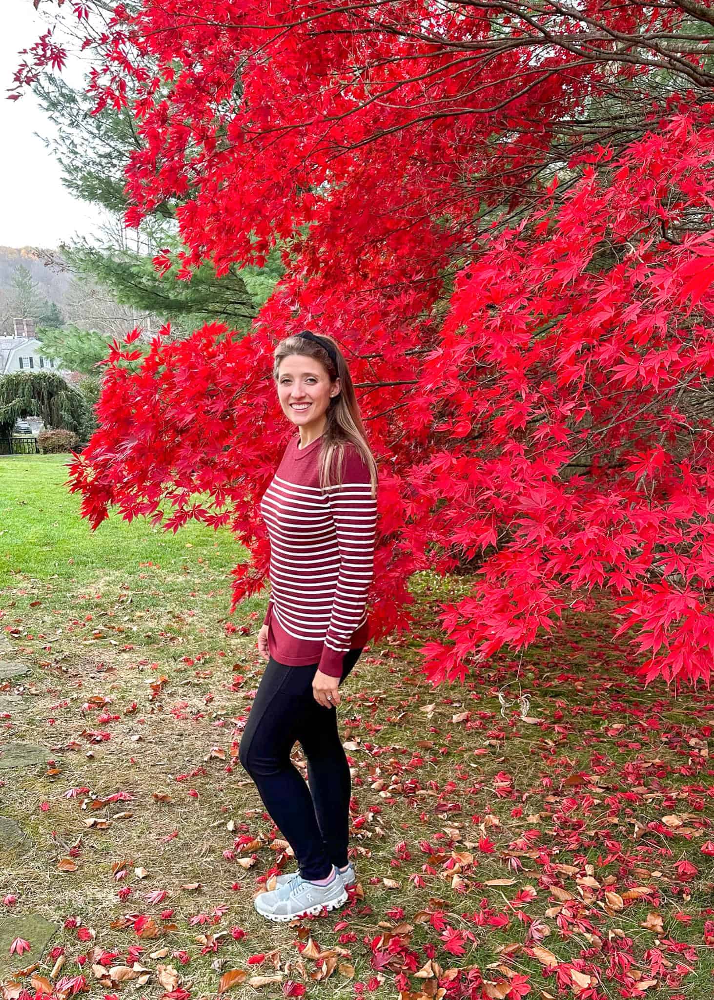 woman standing in front of red tree