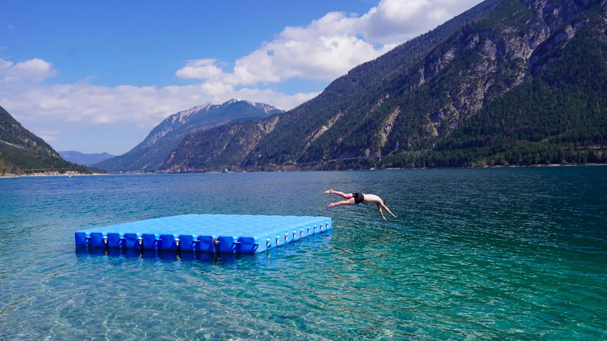man jumping into lake Achensee
