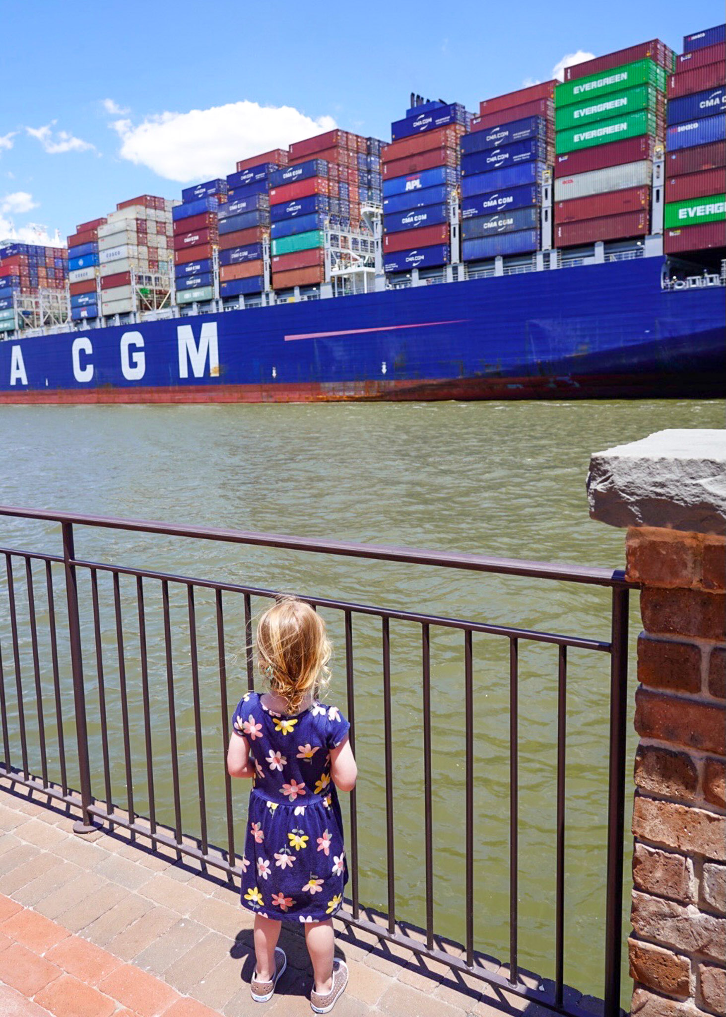girl watching container ships - luxury spring break destinations for families