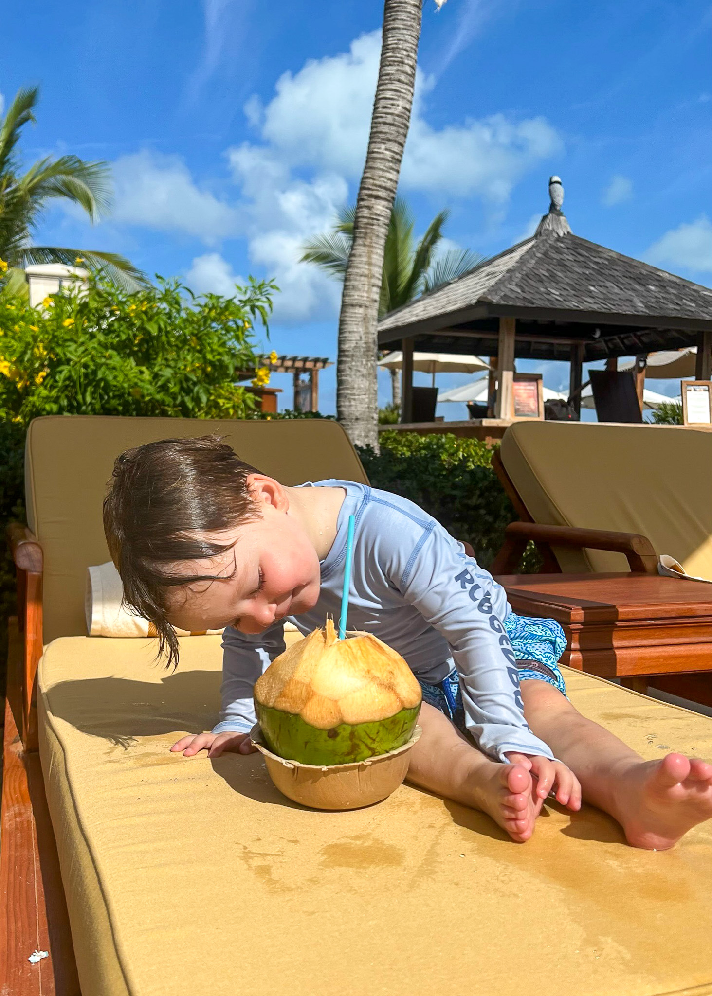 boy drinking coconut water- luxury spring break destinations families