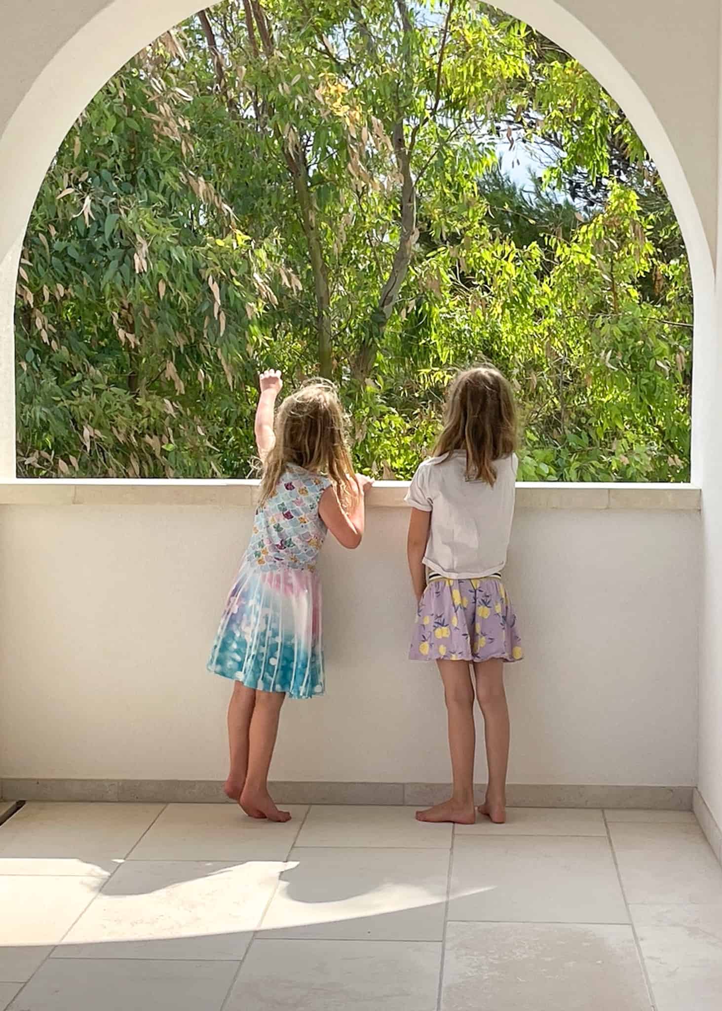 girls looking out a window - villas in puglia