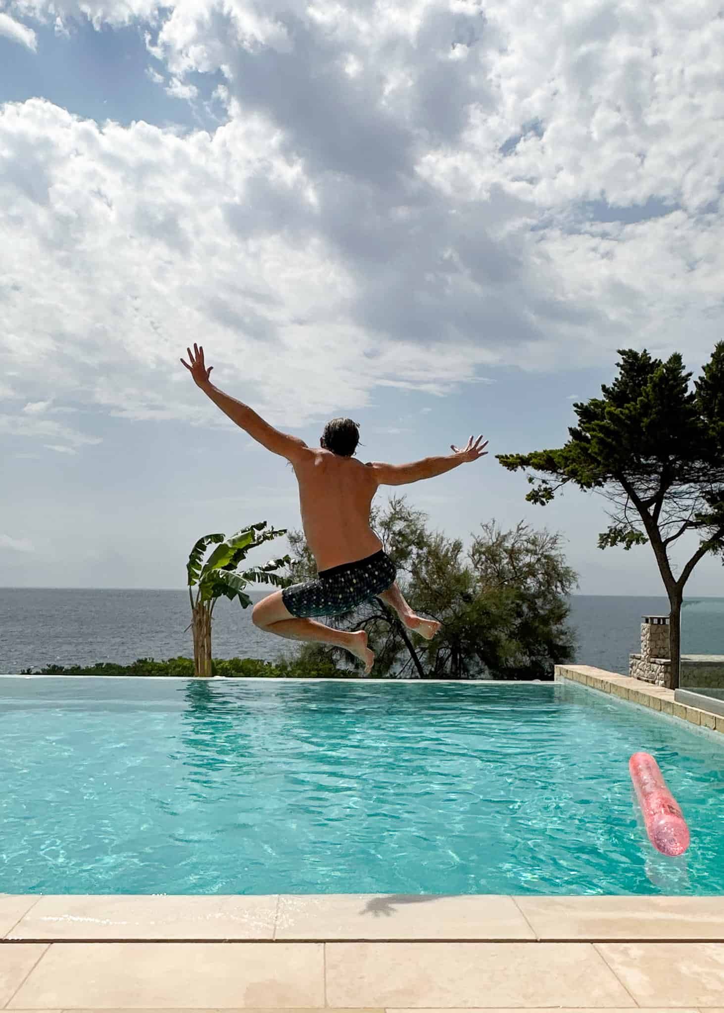 man jumping into pool l'argentiera the thinking traveller