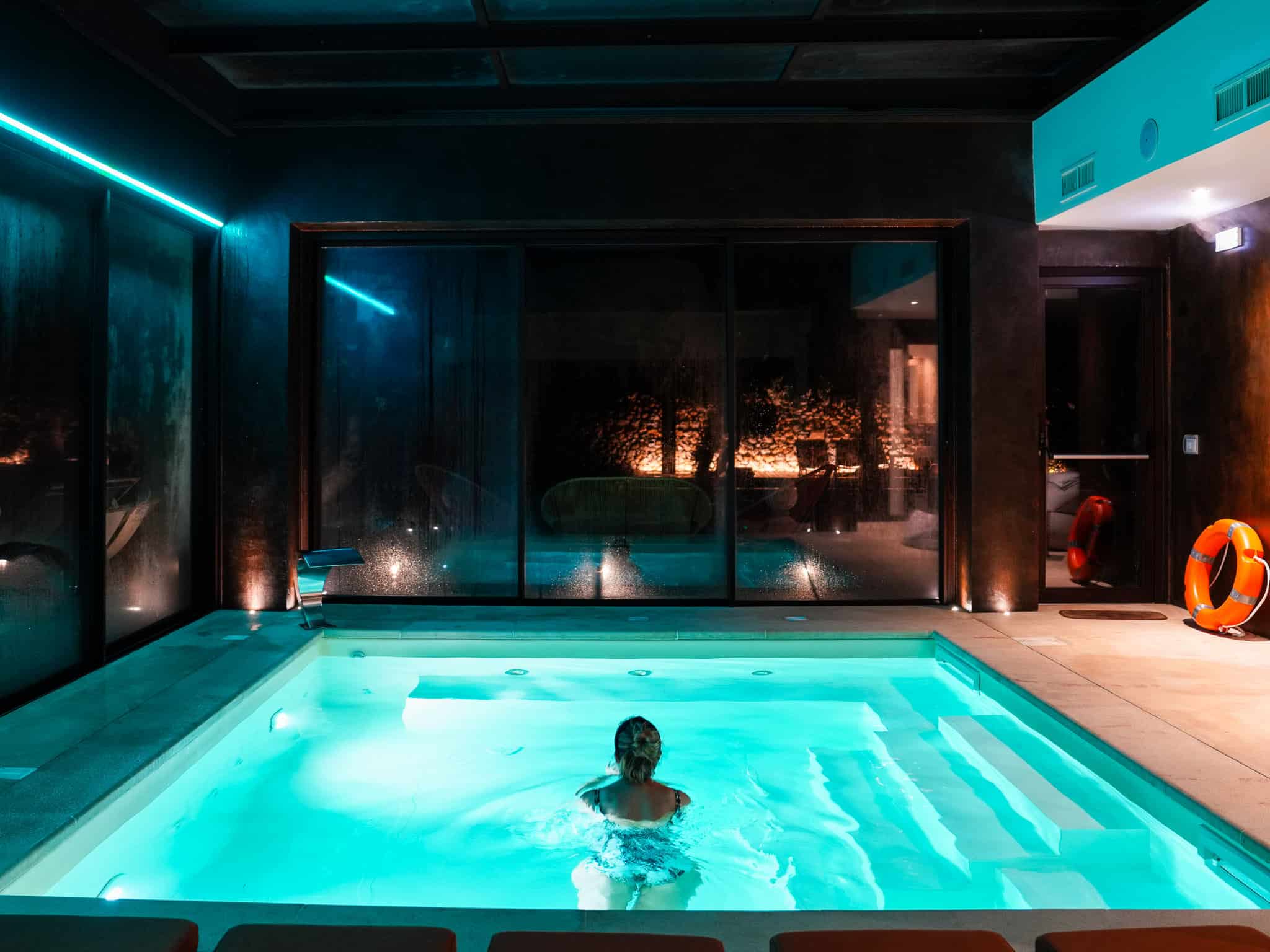 woman swimming at night at tenuta della cava, luxury villa in sicily