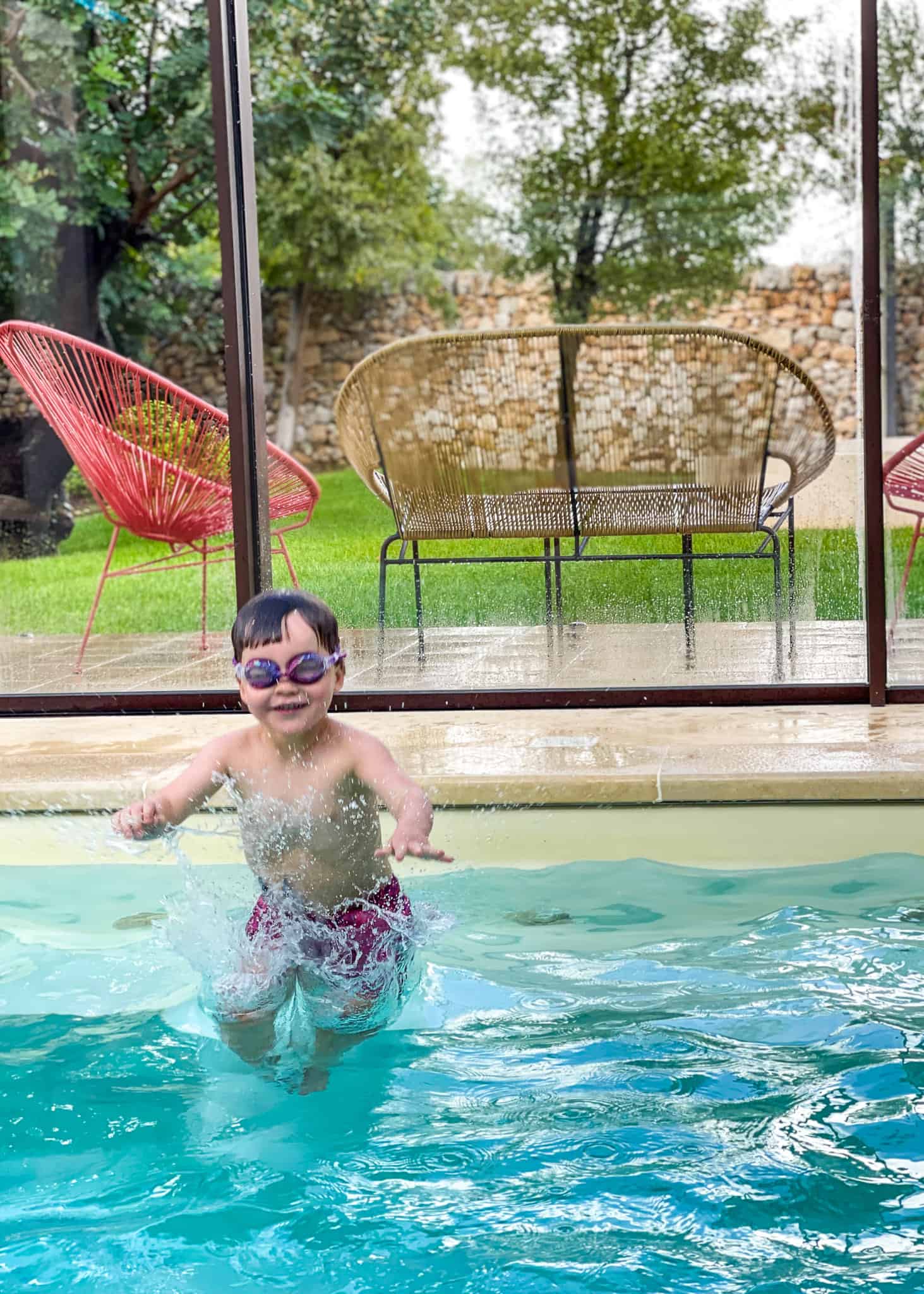 boy jumping into pool, luxury villa in sicily