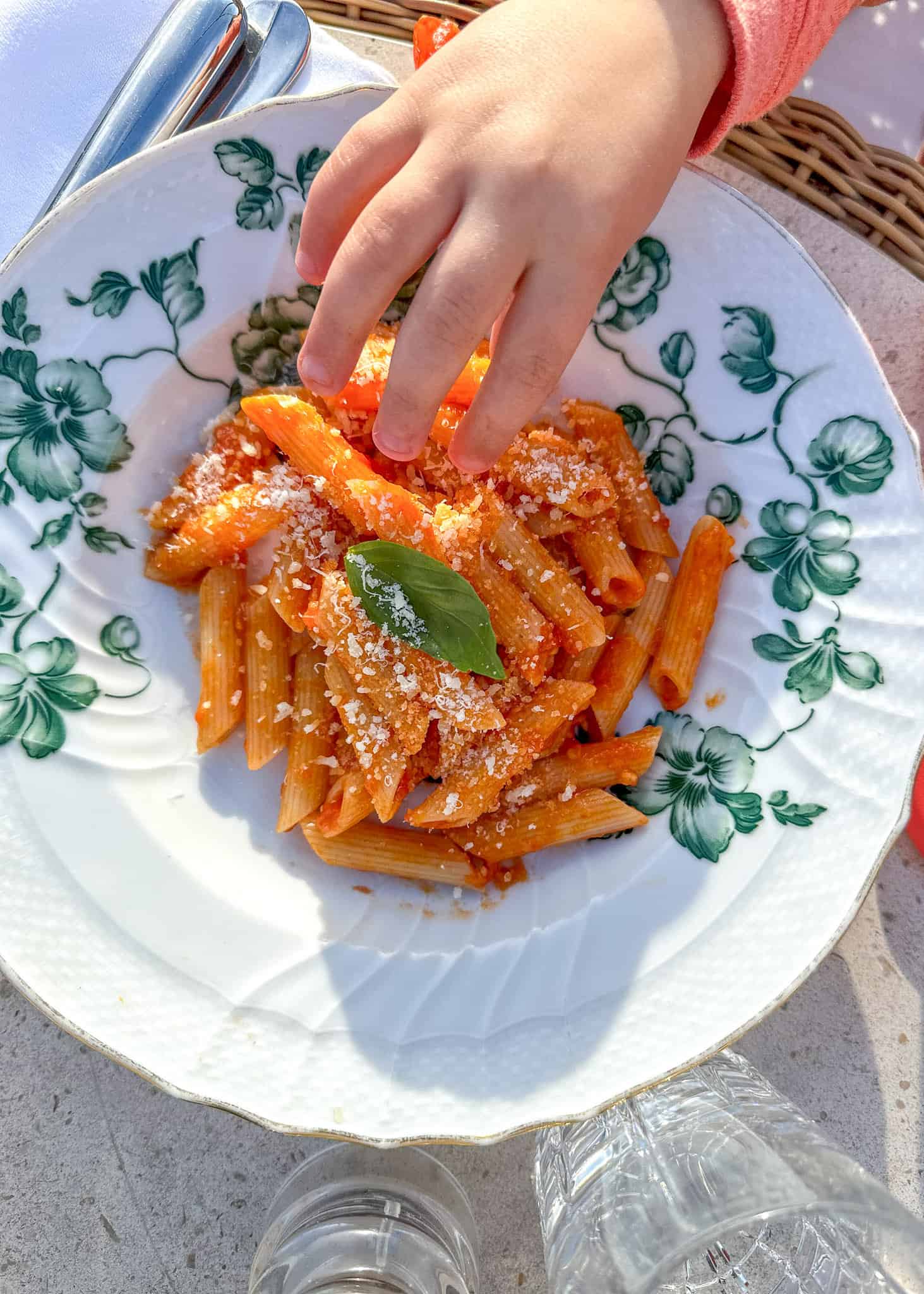 hand reaching into bowl of pasta , sicily